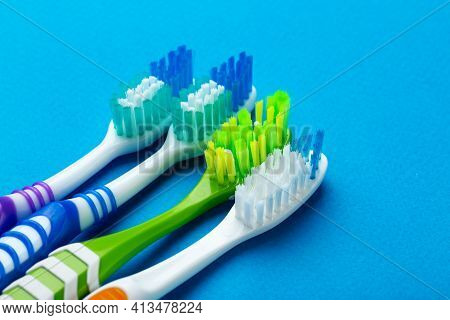 Toothbrushes On A Blue Background. Concept Toothbrush Selection. Oral Cavity Care. Dental Hygiene. T