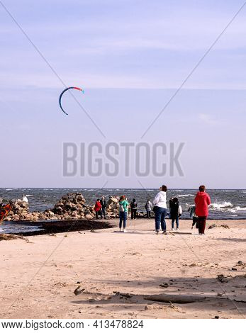 Tourists Take Pictures Of The Lightest Stone Boulders Of The Breakwater On The Coast Of The Gulf Of 