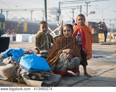 Varanasi. India. 11-02-2018. Mother With Two Children Carrying Some Belongings At The Varanasi Train