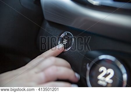 Drivers Hand Finger Presses The Start Stop Button In A Modern Car. Close-up. No Face. Keyless Option
