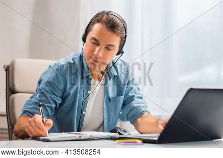 Workplace Of Freelance Worker Or Sudent At Home Office. Young Man Works Using Computer And Other Dev