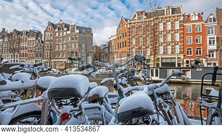 Snowy bikes in Amsterdam in winter in the Netherlands