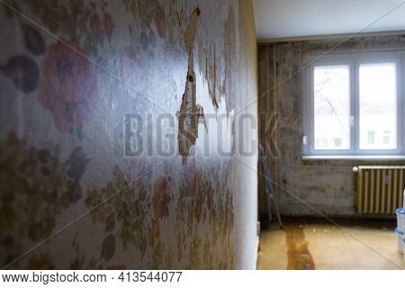 Torn Wallpaper On The Wall Of A Run-down Flat