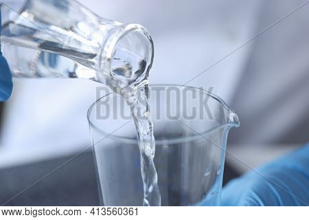 Clear Liquid Is Poured From Glass Bottle