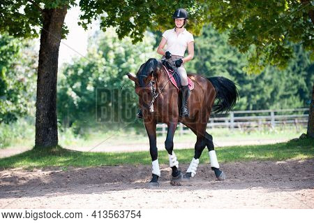 Teenage Girl Equestrian Riding Horseback On Arena At Sport Training. Vibrant Multicolored Outdoors H