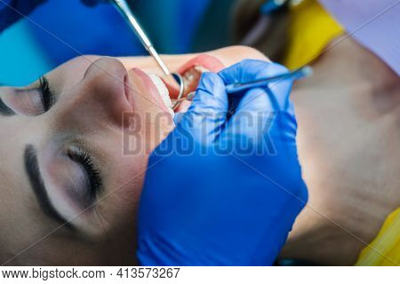 Beautiful woman at the dentist in prophylaxis session