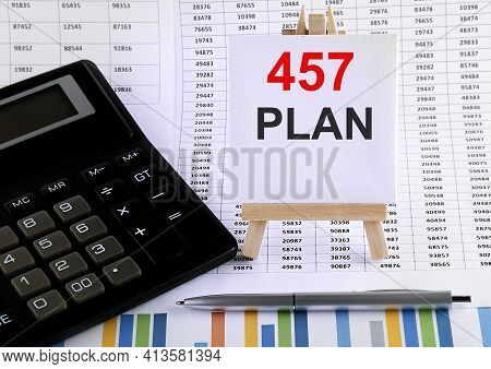 457 Plan On Small Easel With Charts, Pen And Calculator.business