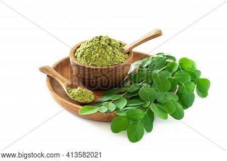 Moringa Powder (moringa Oleifera) In Wooden Bowl With Original Fresh Moringa Leaves Isolated On Whit