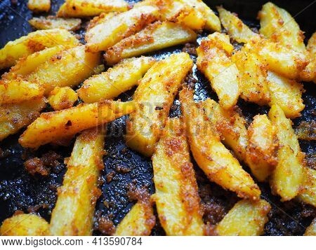 Fried Potatoes Or French Fries With Turmeric, Curry And Bread Crumbs. Close-up. Delicious Side Dish.