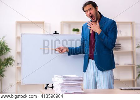Young male employee in oversleeping concept in front of whiteboard