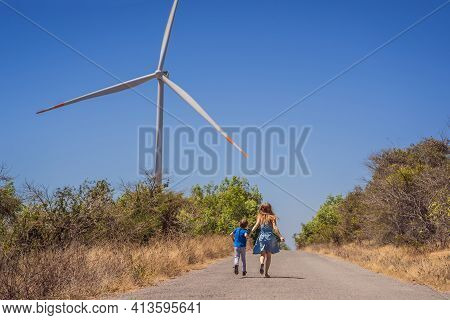 Alternative Energy, Wind Farm And Happy Time With Your Family. Happy Mother On The Road With His Son