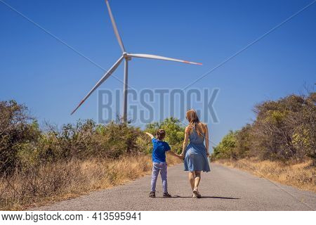 Alternative Energy, Wind Farm And Happy Time With Your Family. Happy Mother On The Road With His Son