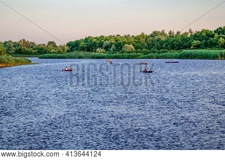 Group Of Kayaks On The Blue Water Surface Of The Konka River On The Background Of A Green Wooded Coa