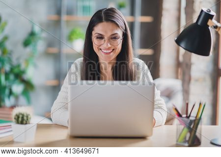 Photo Of Worker Lady Sit Desk Work Computer Look Screen Beaming Smile Wear Eyeglasses White Pullover