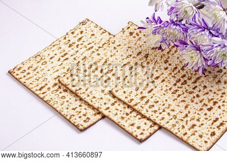 Passover Background With Matzah And White And Purple Chrysanthemums. Jewish Holiday. View From Above