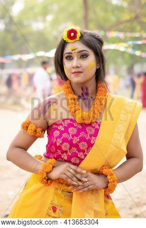 Portrait Of Beautiful Happy Young Indian Woman With Spring Festive Make Up Celebrating Holi With Pow