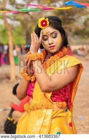 Portrait Of Beautiful Happy Young Indian Woman With Spring Festive Make Up Celebrating Holi With Pow