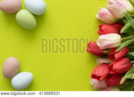 Easter Eggs And Tulips On Light Green Background