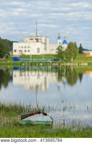 Verkhniye Sergi, Russia - September. 06 2020 On One Bank, An Abandoned, Sunken Rowboat In The Water,