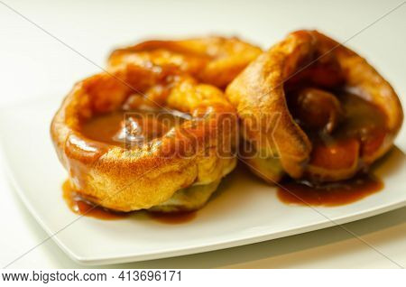 Traditional English Yorkshire Pudding With Meatballs And Thick Gravy Sauce