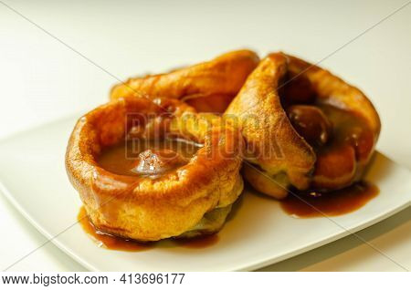 Traditional English Yorkshire Pudding With Meatballs And Thick Gravy Sauce