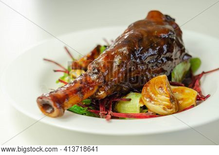 Delicious Lamb Shank With Red Wine And Rosemary Gravy Served On The Mixed Leaf Salad
