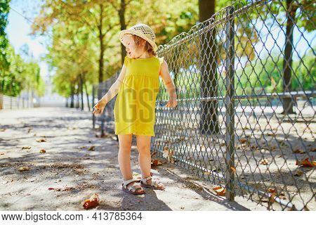 Unhappy And Emotional Toddler Girl In Park. Misbehaving Child Outdoors. Terrible Twos And Kid Tantru