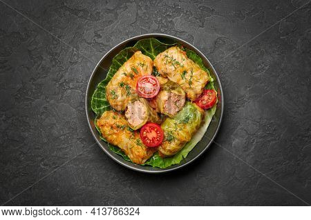 Golubtsi Or Golabki In Black Bowl On Dark Slate Table Top. Stuffed Cabbage Rolls Dish Of Russian, Po
