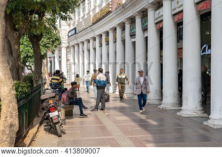 New Delhi, India - December 4, 2019: People And Classic Facades Of Columns At Connaught Place.