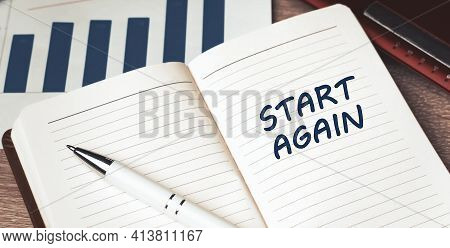The Words Start Again Written On A White Notebook. Closeup Of A Personal Agenda