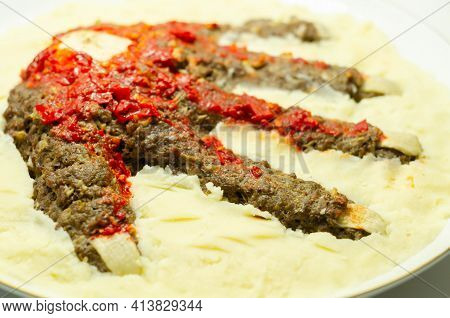 Roasted Minced Meat Formed In The Shape Of A Hand, Topped With A Tomato And Pepper Sauce, A Creative