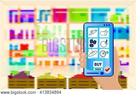 Hand Holds A Mobile Phone With A Grocery Order On Supermarket Blurry Shelves Background. Supermarket