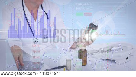Financial data processing against mid section of female doctor holding medicine. global finance and healthcare concept