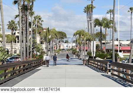 NEWPORT BEACH, CALIFORNIA - JANUARY 6, 2017: Balboa Pier looking towards the boardwalk. The Balboa Peninsula is a popular destination for tourists and locals.