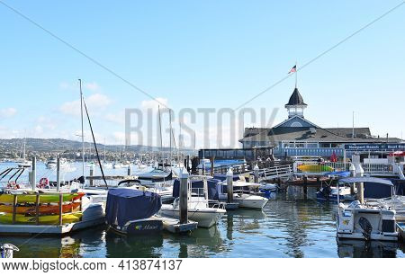 NEWPORT BEACH, CALIFORNIA - JANUARY 6, 2017: The Balboa Pavilion and boats. On Newport Bay the Pavilion is the center of waterfront activities.
