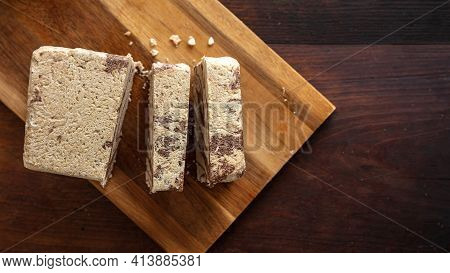 Halva Cocoa Tahini Slices On Wooden Table Background, Top View.