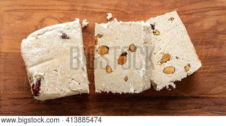 Halva Almond Nuts Slices On Wooden Table Background