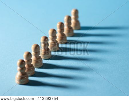 Chess Pieces In A Row, White Pawns On A Blue Background,