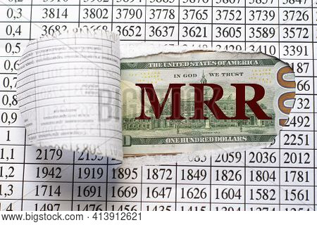 Mrr ( Monthly Recurring Revenue) Is The Acronym Behind Torn Office Paper With Numbers. Business And 