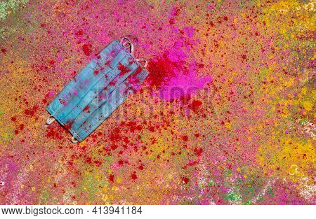 Medical Or Surgical Face Mask On Holi Festival Colors Or Gulal With Copy Space In Horizontal Orienta