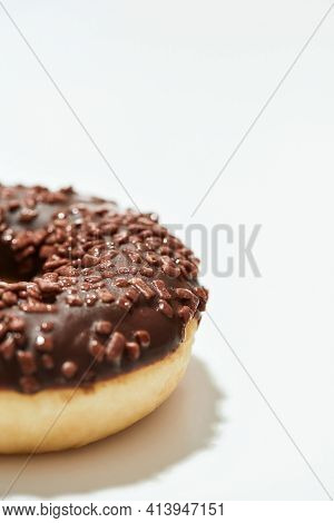 Mmm, So Yummy. Close Up Shot Of A Freshly Baked Delicious Chocolate Donut With Sprinkles On White Ba