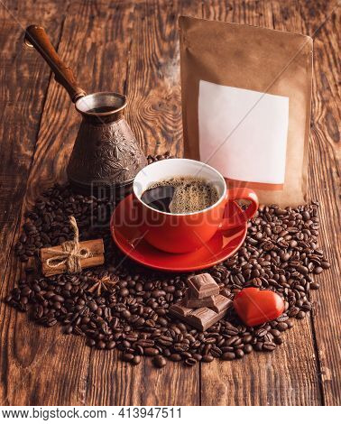 Rred Cup Of Coffee, Heart, Beans, Turkish Coffee Pot, And Craft Paper Pouch Bag On Wooden Backgroun