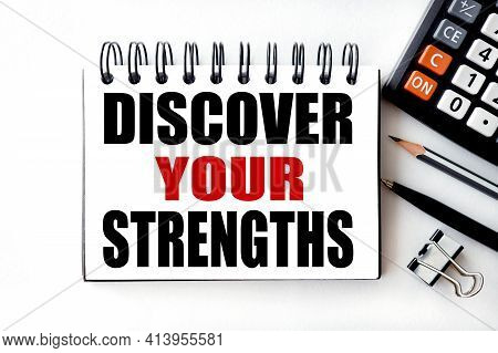 Discover Your Strengths. Text On White Notepad Paper On Light Background Near Calculator, Plant, Tab