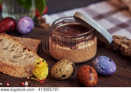 Meat Pate In A Glass Jar On A Cutting Board And Painted Quail Eggs. Easter Background, Meat Delicaci
