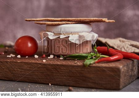 Meat Pate In A Glass Jar On A Cutting Board And Painted Quail Eggs. Easter Background, Meat Delicaci
