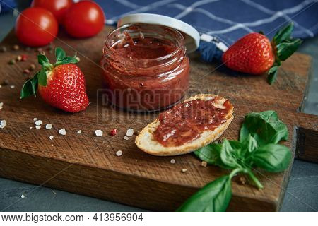Meat Pate In A Glass Jar On A Cutting Board And Painted Quail Eggs. Easter Background, Meat Delicaci