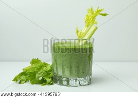 Glass Of Green Smoothie With сelery On White Table
