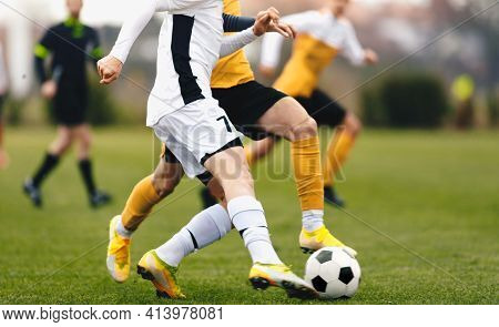 Adult Sports Players In Football Duel Run. Footballers Running Ball At The Game. Youth Soccer League