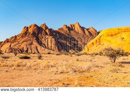 Pontok Mountains Near Spitzkoppe. Red Vivid Granite Rock Formation In Namib Desert At Sunset Time, N