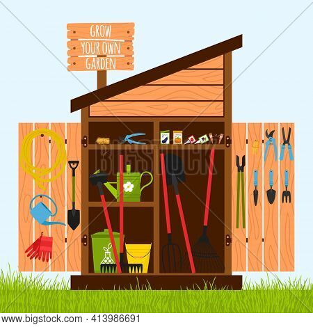Wooden Shed On The Lawn With Open Doors. Gardening Tools Are Stacked Inside On Shelves And Hung On T